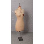 A vintage Yugin & Sons tailors dummy or mannequin. Female in form,