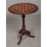 A Victorian walnut games table. Cracks to top.
