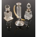 Three silver mounted scent bottles, along with a silver and mother of pearl ring stand.