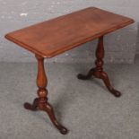 A Victorian mahogany centre table raised on scroll feet supports.