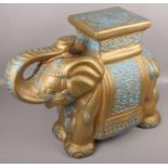 A decorative gilt pottery stand formed as an Indian elephant.