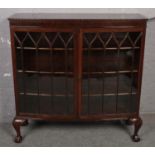 A mahogany display cabinet raised on ball and claw supports. (122cm x 122cm x 41cm)