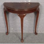 A carved mahogany demi lun side table.