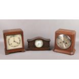 Three oak cased mantel clocks. An Elliot oak cased 8 day mantel clock, Norland and a carved
