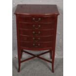 A mahogany bow front music cabinet with x frame support. (89cm x 54cm)