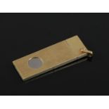A 14ct gold cased steel cigar cutter. With reeded case and suspension loop stamped 585, 19.8 grams