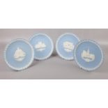 Four Wedgwood blue Jasperware plates, Christmas 1980, 1981, 1983, 1984.