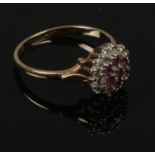 A 9ct gold ruby and diamond cluster ring, size P.