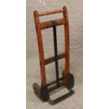 A vintage wrought iron and wood sack barrow.