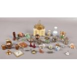 A box of dolls house miniatures including three cold painted spelter telephones, celluloid commode