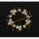 An Edwardian 15ct gold, seed pearl and turquoise wreath brooch. Stamped 15.
