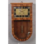 An Art Deco walnut cased 8 day wall clock. With black and gilt rectangular dial and striking on a