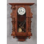 A Gustav Becker walnut cased 8 day Vienna wall clock. Some mouldings detached. With additional