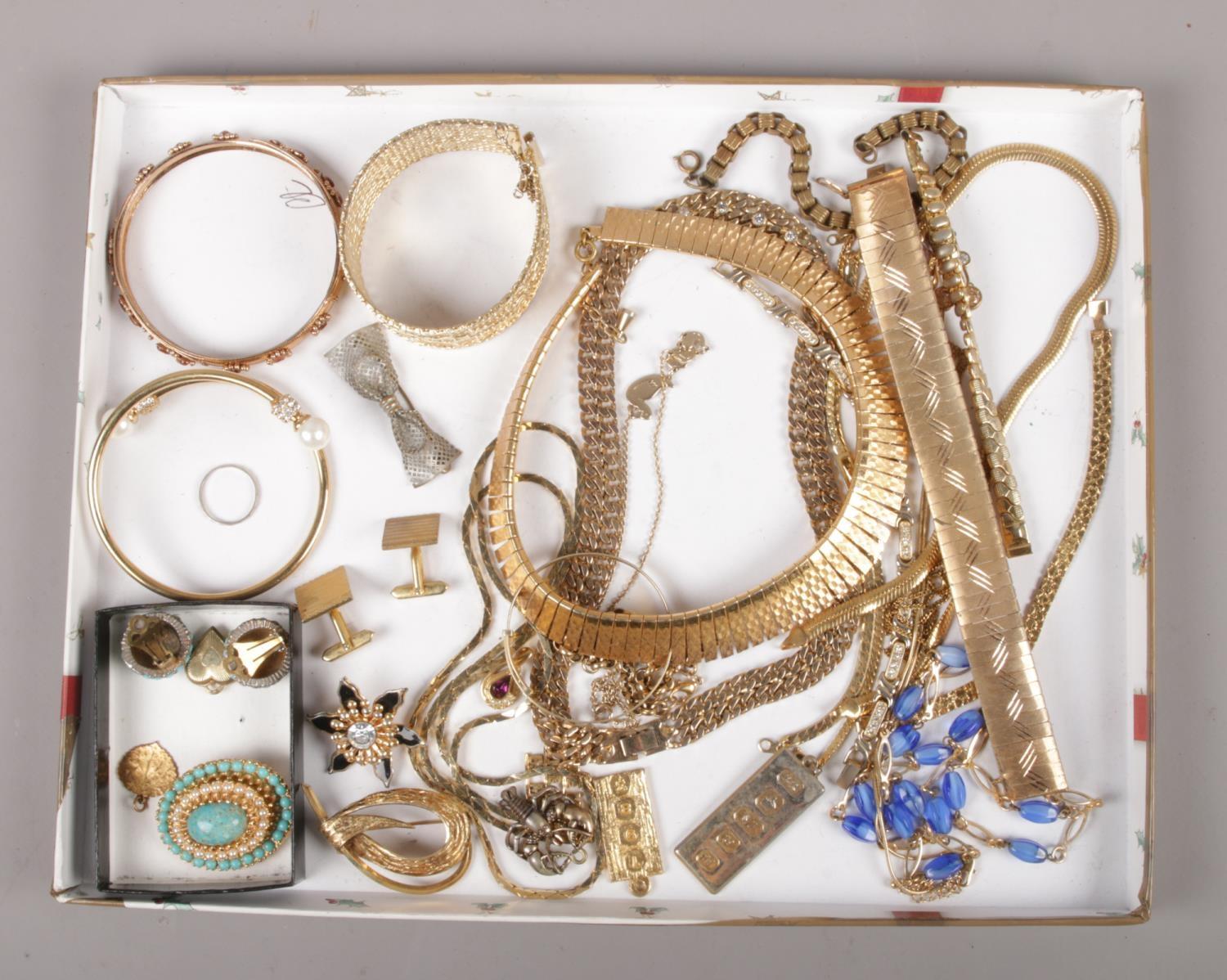 A collection of gilt metal costume jewellery, to include brooches, bracelets, cufflinks etc.