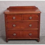 A Victorian mahogany two over two chest of drawers with moulded glass drawer pulls, 100cm x 48cm,