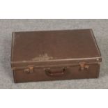 A vintage suitcase to include two ladies hats and gloves