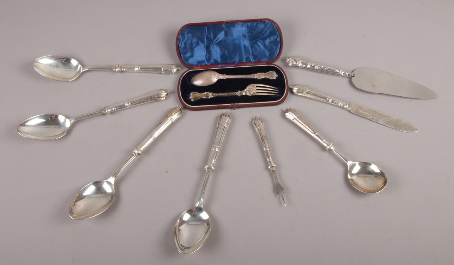A cased Victorian silver fork and spoon, along with a collection of silver handled cutlery.