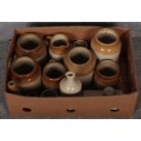 A box of stoneware to include utility jars, advertising bottles, etc.