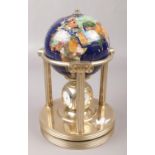 A hardstone set world globe, raised on brass ionic pillars with clock hygrometer and thermometer