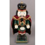 A painted wooden novelty nut cracker formed as a soldier.
