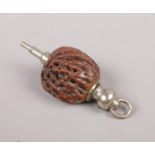 A propelling pencil chain fob formed from a peach pit, for a pocket watch chain.