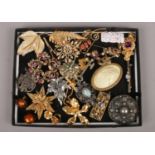 A tray of costume brooches to include Trifari, Auri, Monet etc.