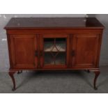 A mahogany sideboard with glass middle cabinet, raised on cabriole supports. (122cm x 94cm)