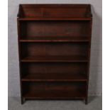 An oak five shelve open bookcase. (140cm x 95cm)