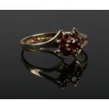 A 9ct gold garnet cluster ring, Size P. (1.47g).