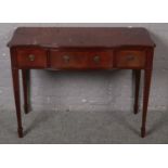 A mahogany three drawer side table raised on reeded tapering supports. (105cm x 80cm)