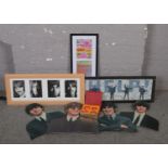 A collection of The Beatles memorabilia, to include glass apple paperweights, cut outs, prints,