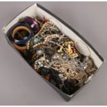 A box of costume jewellery to include bangles, necklaces, beads, bracelets etc.