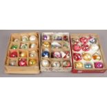 Three boxes of vintage glass baubles to include different colours and sizes.