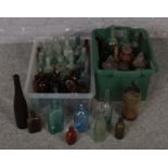 Two boxes of vintage glass bottles to include advertising and coloured examples etc.