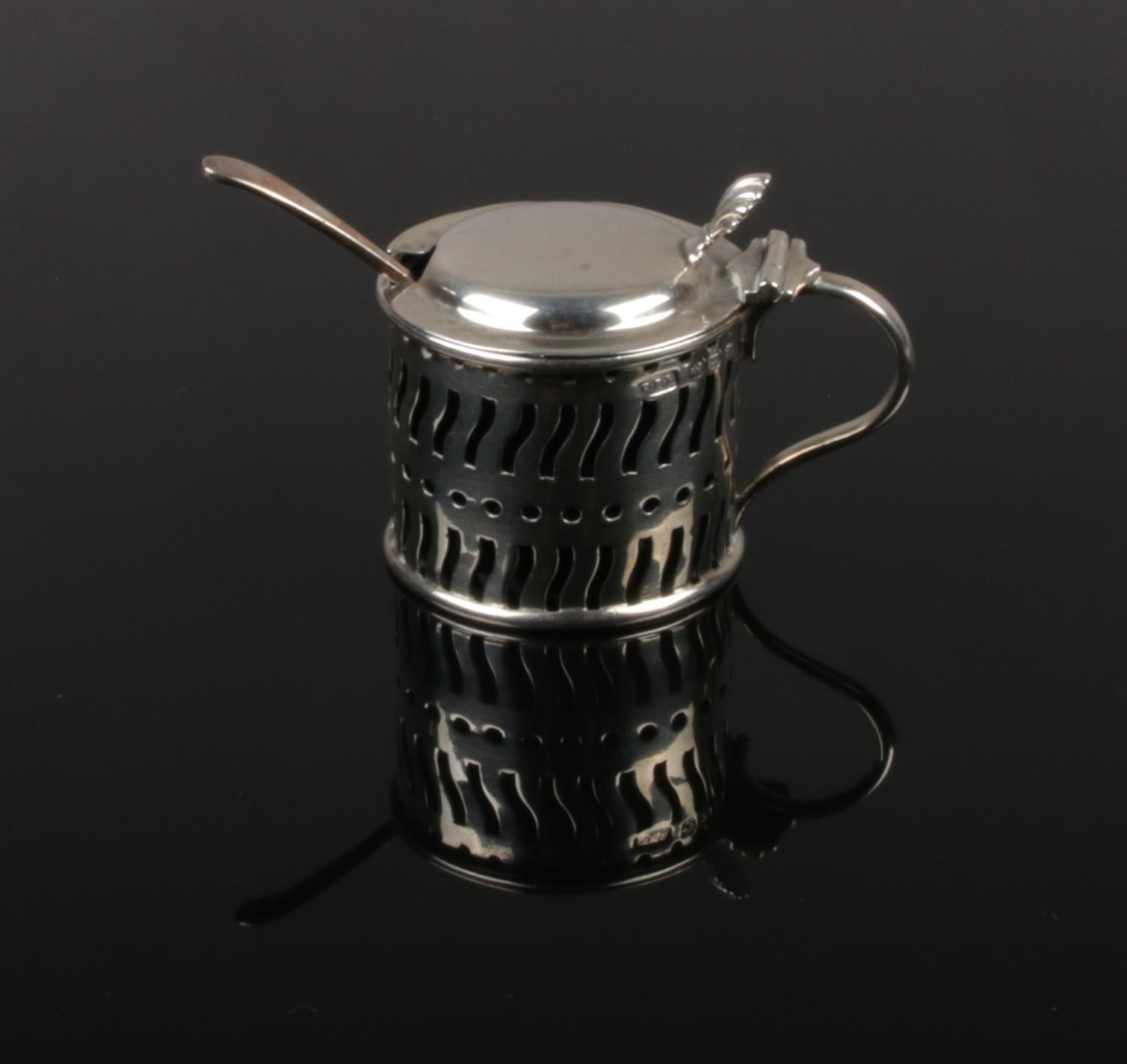 A Victorian pierced silver mustard pot with Bristol blue glass liner. Assayed Birmingham 1894, 29