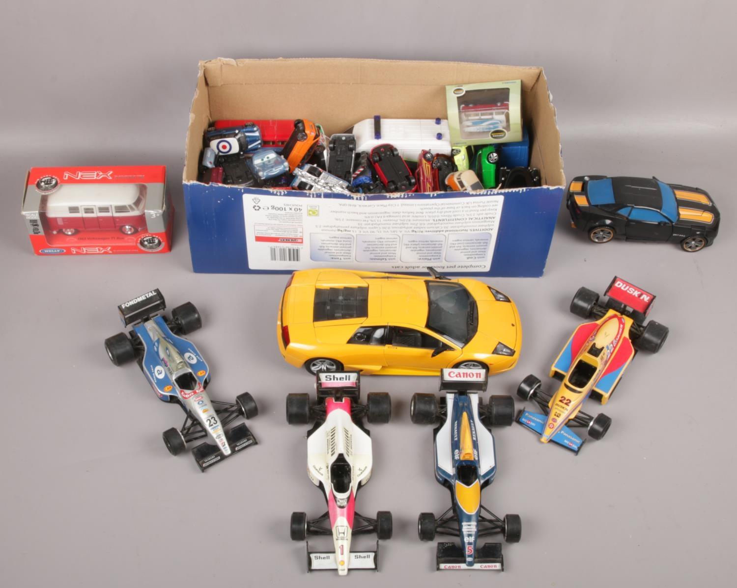 A box of diecast vehicles to include Bruago Formula 1 cars, large Maisto Lamborghini etc.