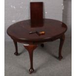 A Victorian mahogany wide out dining table raised on cabriole legs. (150cm x 105cm)