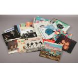 A box of 45 rpm singles, Foreigner, Bob Marley, Elton John, Abba examples