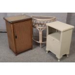 A Lloyd loom bedside cabinet along with another Lloyd loom cabinet and a glass top side table.