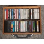 A wooden case of cassette tapes, to include Cat Stevens, Abba, The Rolling Stones etc.