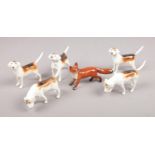 A Beswick fox and five hounds. One hound with repair to tail.