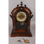 A carved mahogany 8 day mantel clock with gilt & enamel dial.