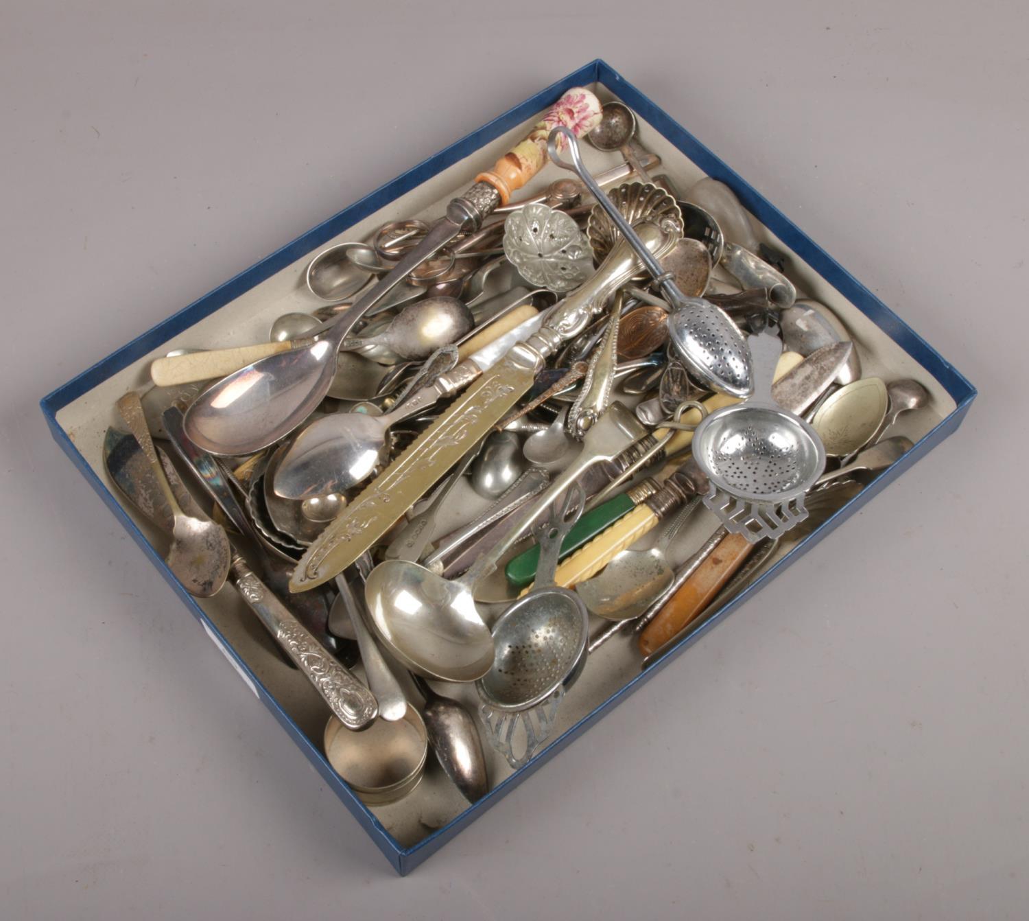 A tray of silver plate flatware to include cake knife, ladles etc.