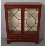 A mahogany china cabinet with three drawer base. (113cm x 92cm)