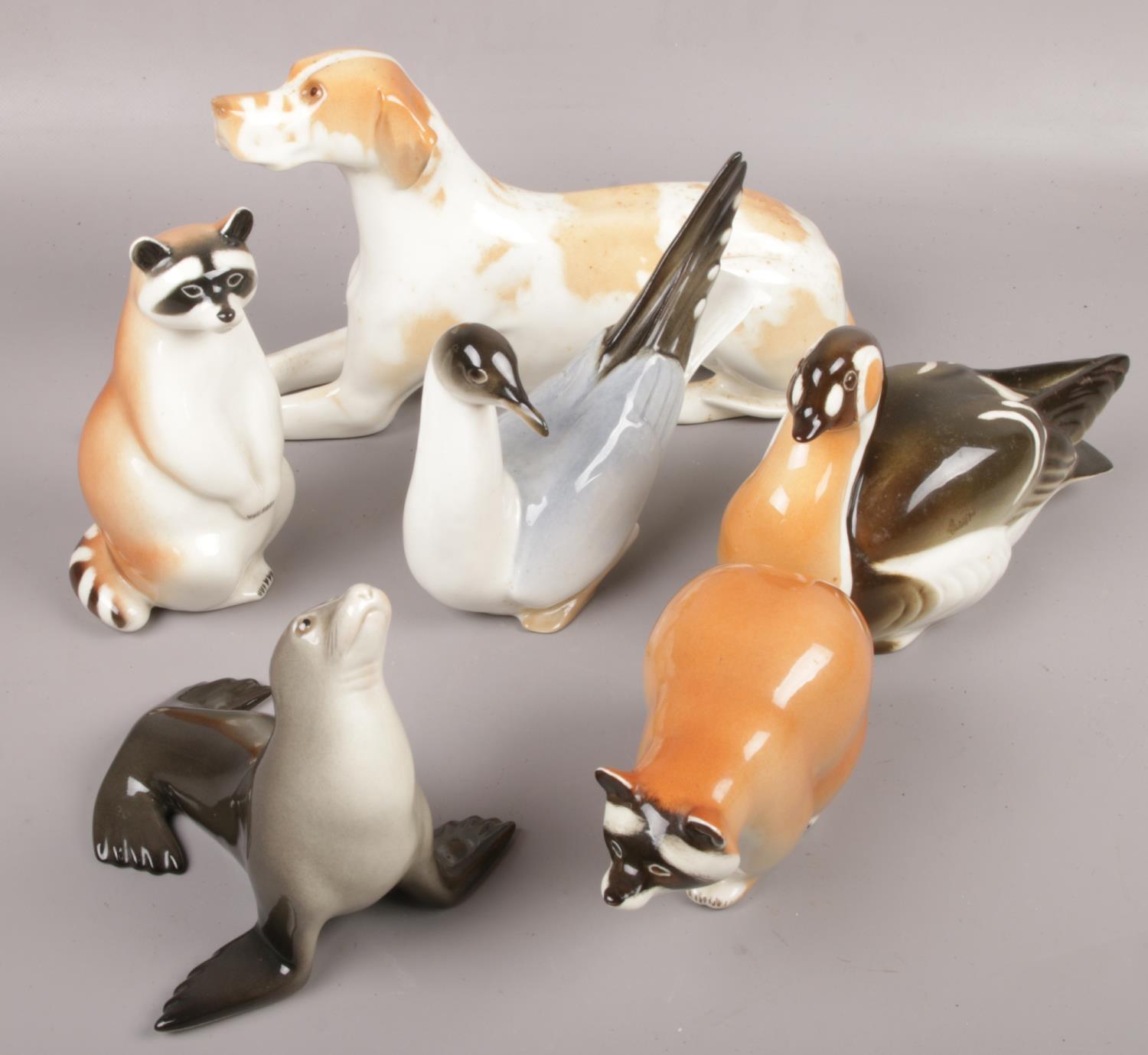 A collection of Russian ceramic animals to include Racoon, Seal, Dog etc.