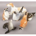 A collection of Russian ceramic animals to include Racoon, Seal, Dog etc.