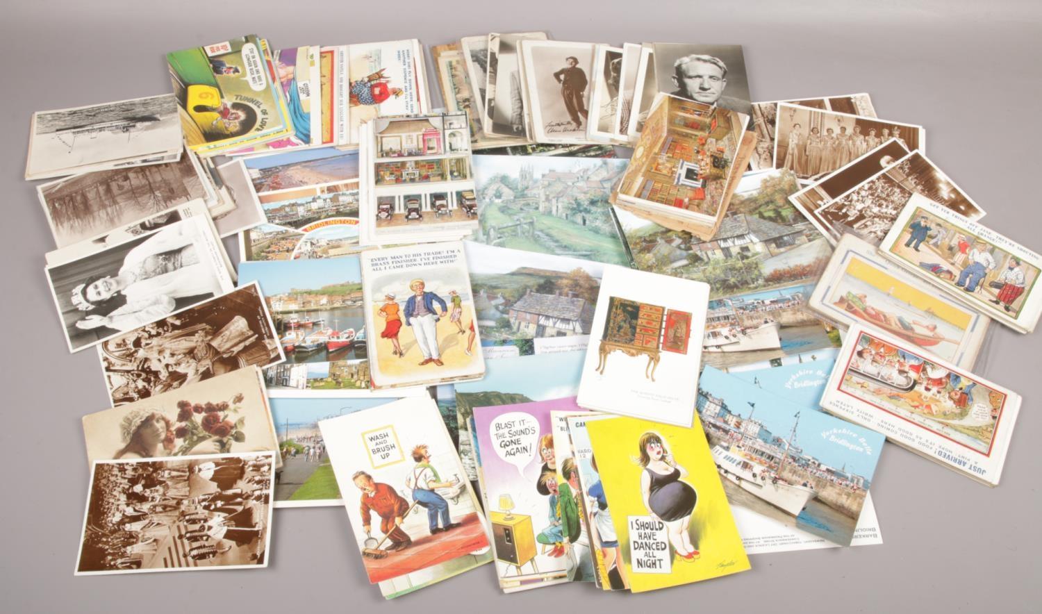 A tin of postcards to include humorous, monochrome, photograph examples etc.