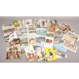 A tin of postcards to include humorous, monochrome, photograph examples etc.