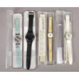 Four cased quartz Swatch wristwatches.
