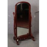 A large ornate mahogany cheval mirror, with bevel edge glass.